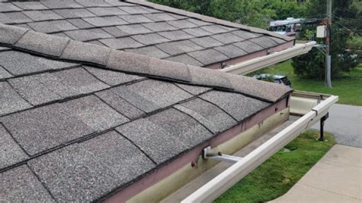 How far should shingles hang over roof edge?