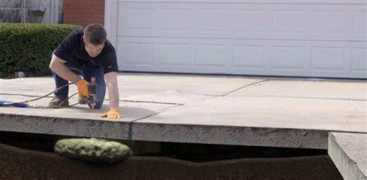 Should you put plastic under concrete driveway?