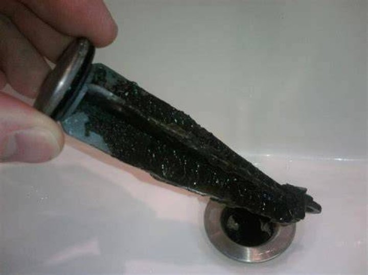 What causes black gunk in shower head?