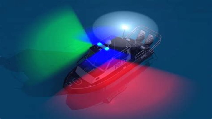 What does a flashing blue light indicate on a boat?