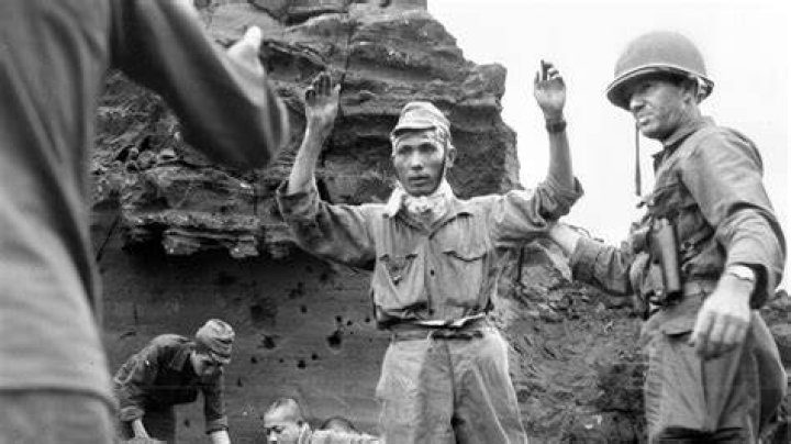 Why did one American soldier describe the Japanese as not on Iwo Jima but in it?